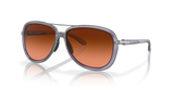 Sunglasses with brown gradient lenses and gray frame on a white background. Oakley split time lilac sunglasses