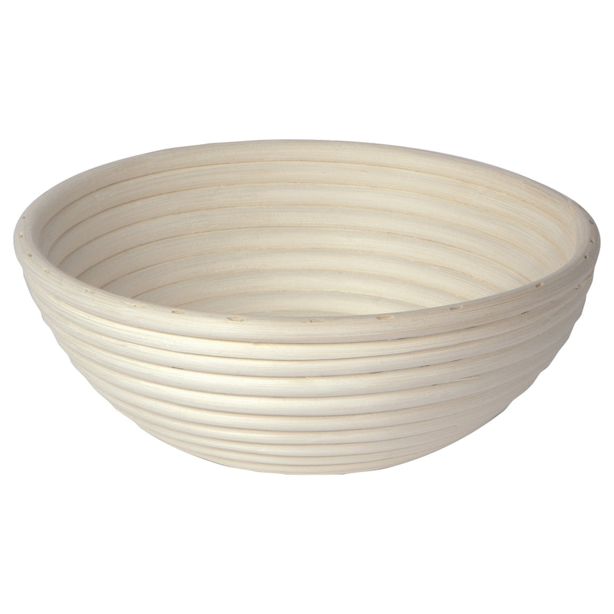 Round woven bread proofing basket on a white background